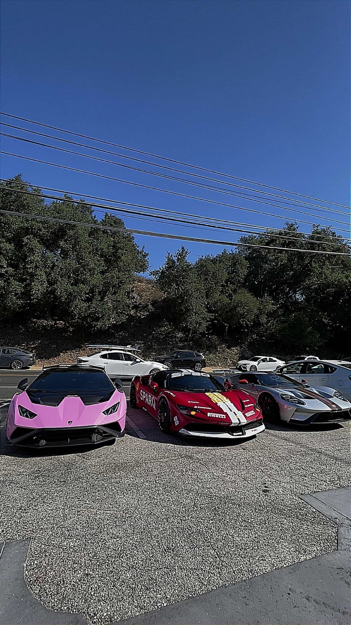 Three cars parked side by side on the lot