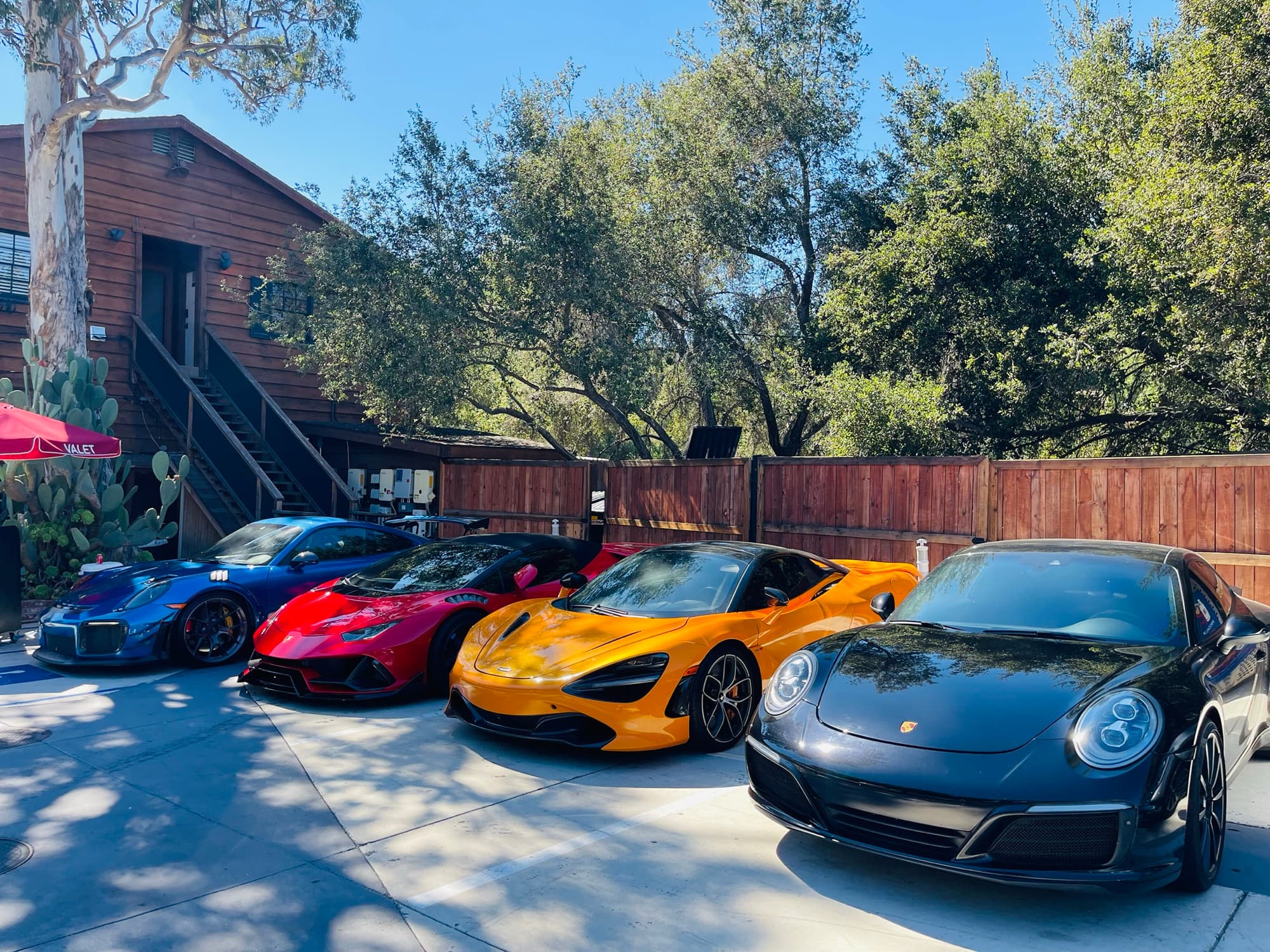 Four cars lined up beside the valet stand
